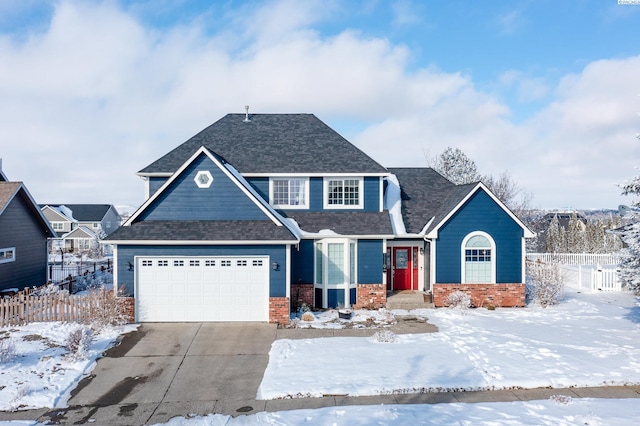 view of front facade featuring driveway, roof with shingles, fence, and brick siding