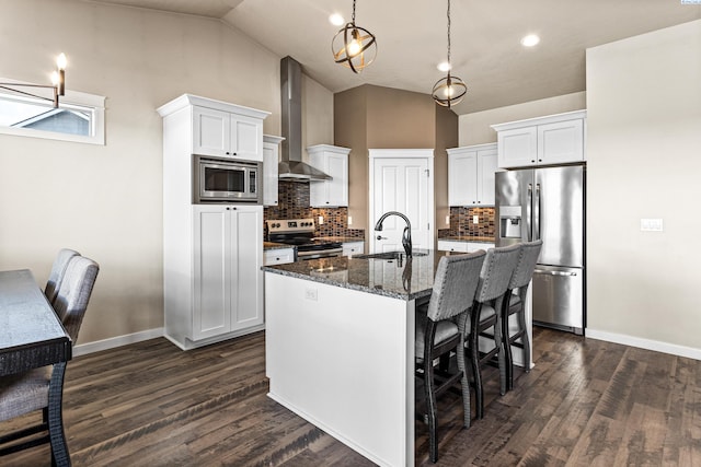 26 Molly Rose Ct, Prosser, WA 99350 - kitchen featuring white cabinetry, a breakfast bar area, stainless steel appliances, a sink, and wall chimney range hood