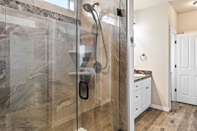 26 Molly Rose Ct, Prosser, WA 99350 - bathroom featuring a stall shower, baseboards, vanity, and wood finish floors