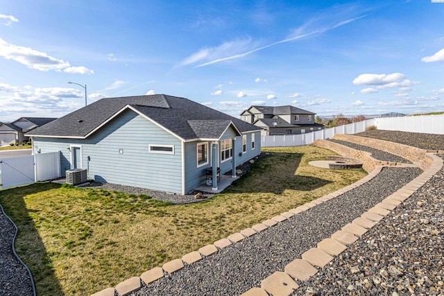 26 Molly Rose Ct, Prosser, WA 99350 - view of property exterior with a gate, a fenced backyard, a fire pit, cooling unit, and a yard