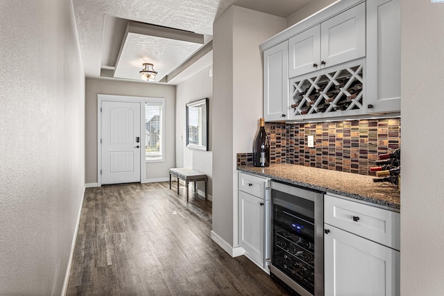 26 Molly Rose Ct, Prosser, WA 99350 - bar with wine cooler, baseboards, backsplash, dark wood-style floors, and a dry bar