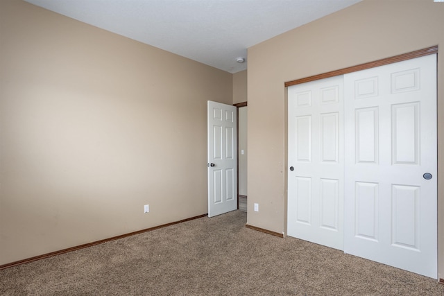 615 N Larkspur Dr, Othello, WA 99344 - unfurnished bedroom with a closet, baseboards, and carpet