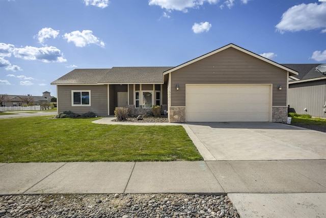 615 N Larkspur Dr, Othello, WA 99344 - ranch-style home featuring an attached garage, driveway, a front yard, and stone siding