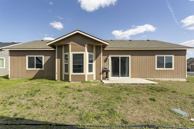 615 N Larkspur Dr, Othello, WA 99344 - rear view of house with a patio area, roof with shingles, and a lawn