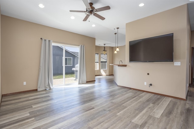 615 N Larkspur Dr, Othello, WA 99344 - unfurnished living room featuring light wood-style floors, baseboards, a ceiling fan, and recessed lighting