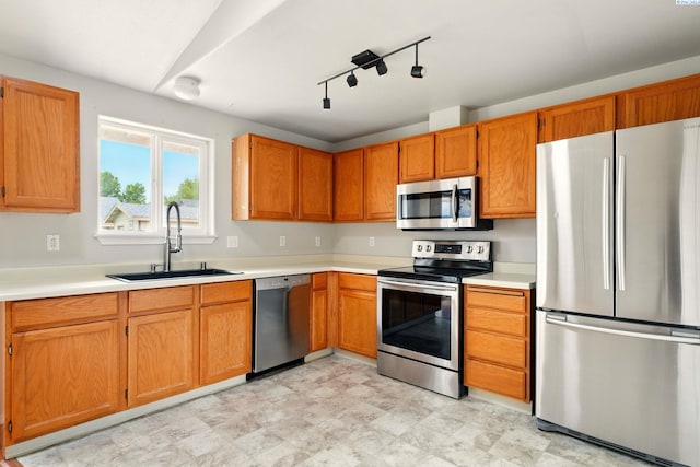 4721 Holly Way, West Richland, WA 99353 - kitchen with appliances with stainless steel finishes, a sink, light countertops, and brown cabinetry