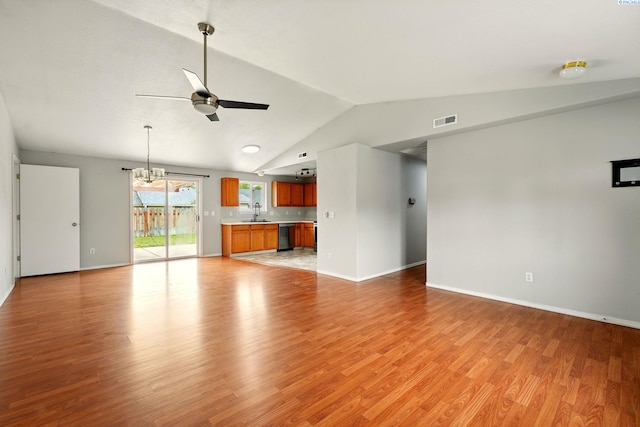 4721 Holly Way, West Richland, WA 99353 - unfurnished living room featuring a ceiling fan, lofted ceiling, a sink, a chandelier, and light wood-style floors