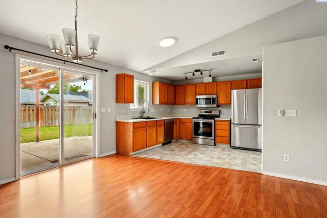 4721 Holly Way, West Richland, WA 99353 - kitchen with appliances with stainless steel finishes, light countertops, vaulted ceiling, a chandelier, and light wood-style floors
