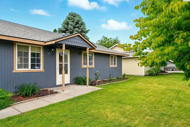 4721 Holly Way, West Richland, WA 99353 - view of side of home with a lawn and roof with shingles