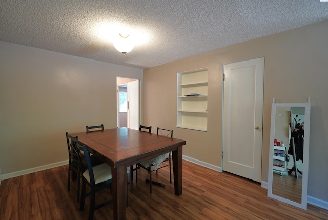 1004 NE D St, Pullman, WA 99163 - dining area with a textured ceiling, wood finished floors, built in shelves, and baseboards