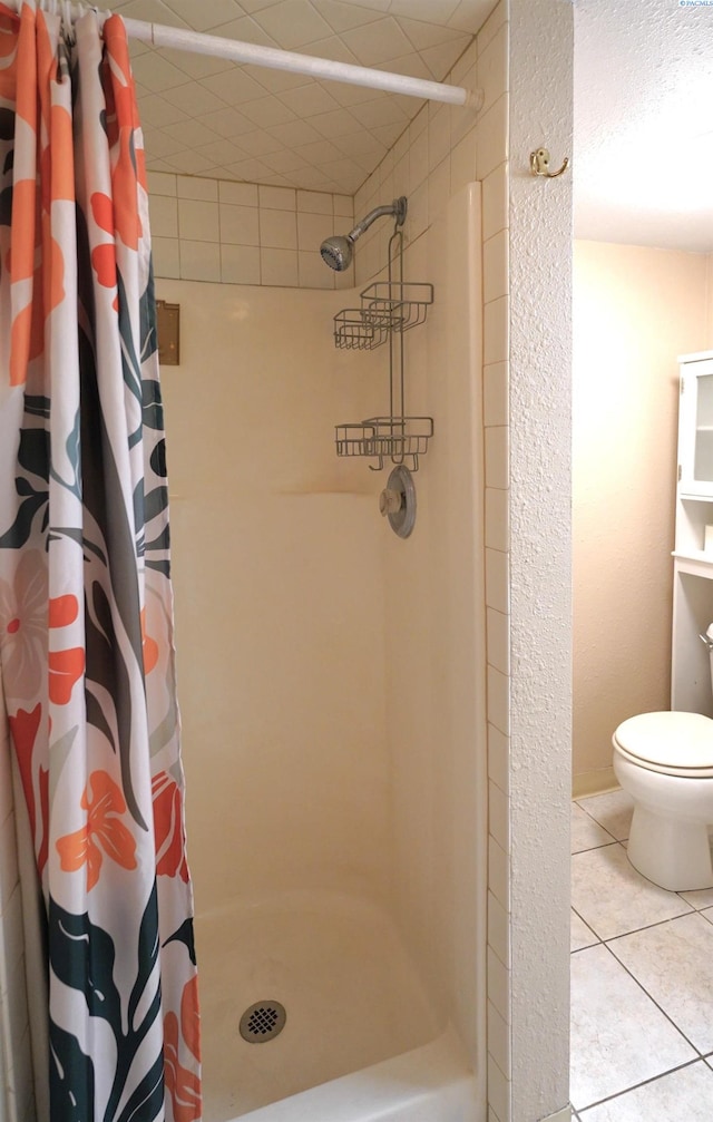 1004 NE D St, Pullman, WA 99163 - bathroom featuring toilet, a stall shower, and tile patterned floors