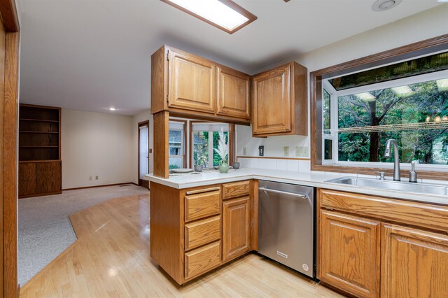 1741 April Loop, Richland, WA 99352 - kitchen with stainless steel dishwasher, light countertops, light wood finished floors, and open floor plan