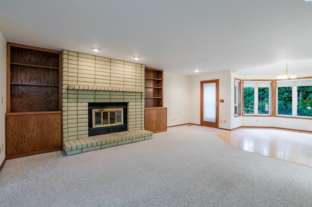 1741 April Loop, Richland, WA 99352 - unfurnished living room with carpet flooring, a brick fireplace, a chandelier, and recessed lighting