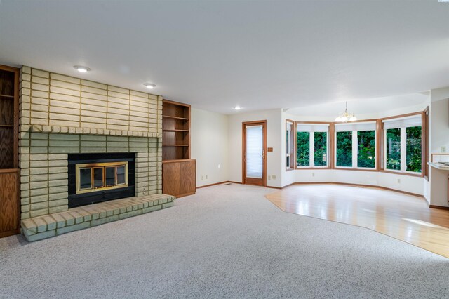 1741 April Loop, Richland, WA 99352 - unfurnished living room with carpet flooring, a chandelier, a brick fireplace, and recessed lighting