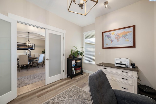 office area featuring light hardwood / wood-style floors, french doors, and a chandelier