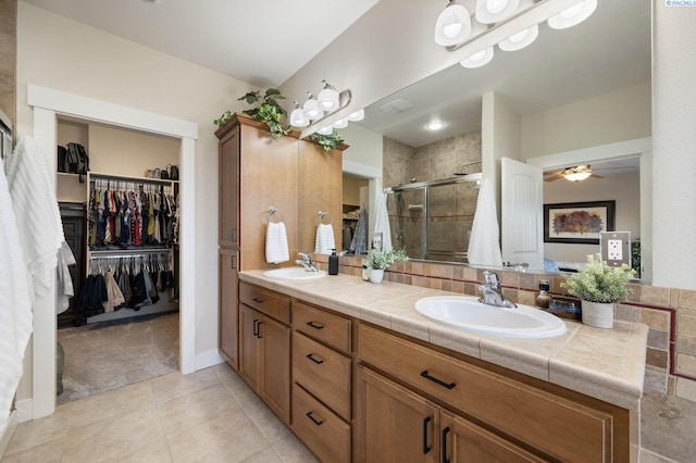 bathroom with vanity, tile patterned floors, and walk in shower