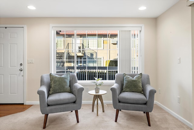 sitting room with light colored carpet