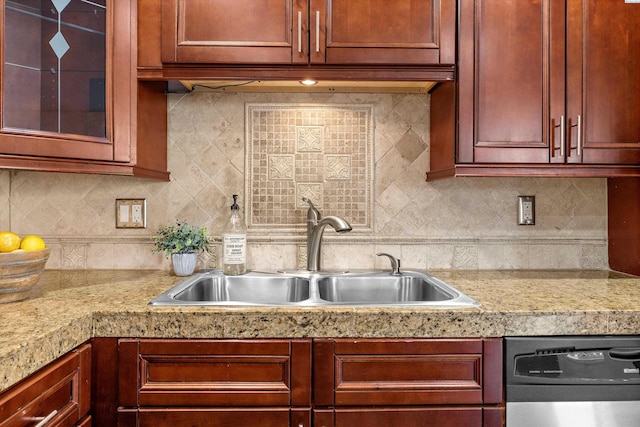 kitchen with tasteful backsplash, dishwasher, and sink