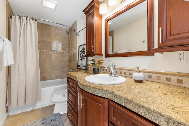 full bathroom featuring tile patterned flooring, vanity, toilet, and shower / bath combo with shower curtain