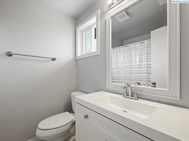full bathroom with toilet and vanity