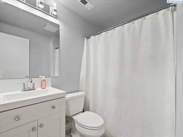 bathroom with toilet and vanity