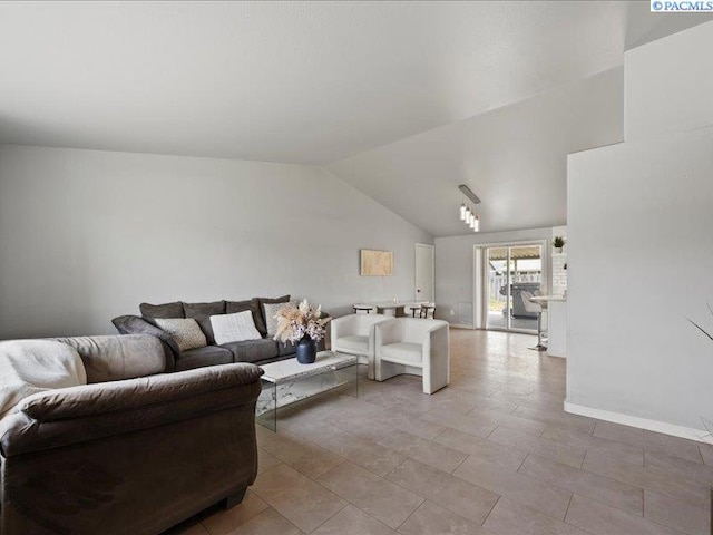 living room with vaulted ceiling and baseboards