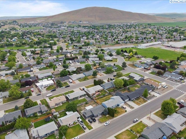 aerial view of property and surrounding area featuring mountains