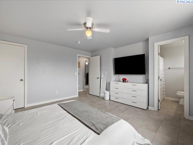 bedroom with baseboards, ceiling fan, and connected bathroom