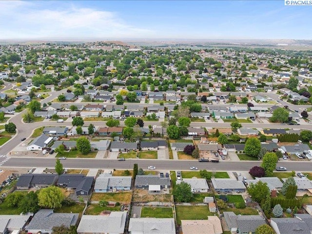 aerial view of property and surrounding area with nearby suburban area