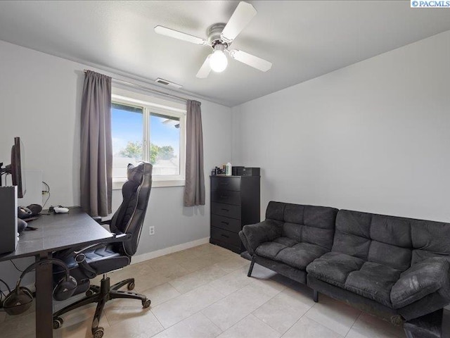 home office featuring ceiling fan, light tile patterned flooring, and baseboards