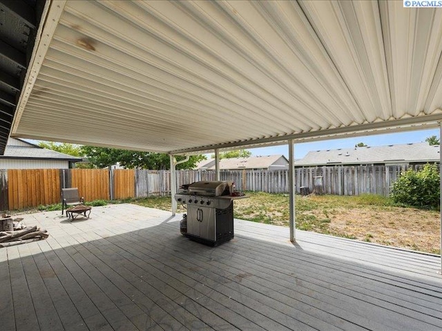 wooden deck featuring a fenced backyard and grilling area