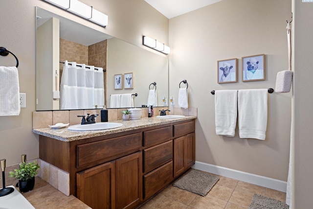 bathroom with vanity, curtained shower, and tile patterned flooring