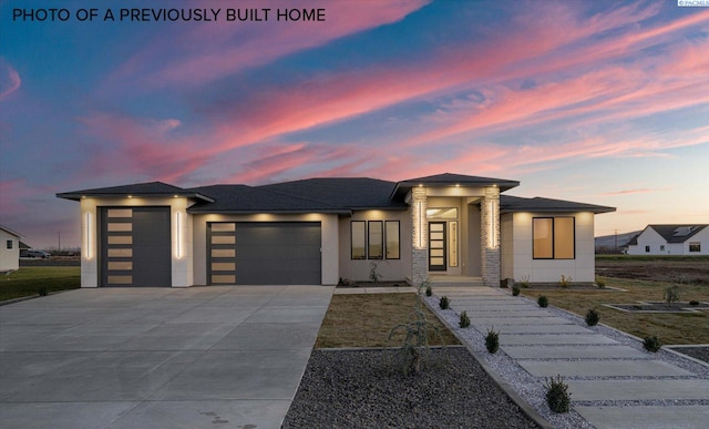 2260 Belfair St Unit 5, Kennewick, WA 99338 - prairie-style home featuring a garage, driveway, stucco siding, and roof with shingles