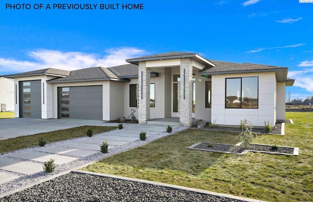 2260 Belfair St Unit 5, Kennewick, WA 99338 - prairie-style house featuring a shingled roof, a front lawn, stucco siding, concrete driveway, and a garage