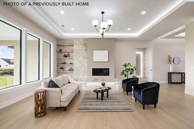 2260 Belfair St Unit 5, Kennewick, WA 99338 - living area featuring baseboards, wood finished floors, a tray ceiling, and a premium fireplace