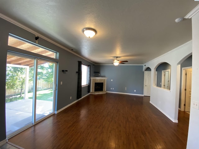 2002 Diamond Head Way, West Richland, WA 99353 - unfurnished living room featuring ornamental molding, ceiling fan, dark wood finished floors, a tiled fireplace, and a textured ceiling