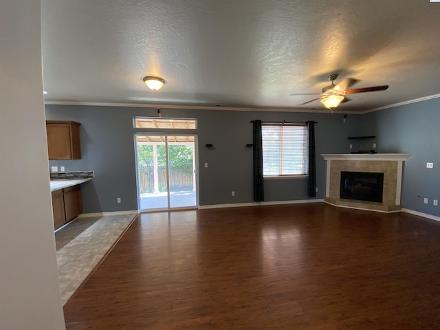 2002 Diamond Head Way, West Richland, WA 99353 - unfurnished living room featuring wood finished floors, ornamental molding, a ceiling fan, a tile fireplace, and a textured ceiling
