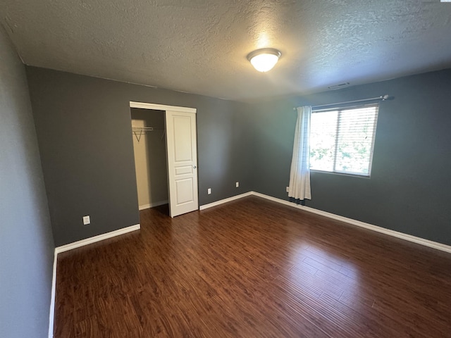 2002 Diamond Head Way, West Richland, WA 99353 - unfurnished bedroom with a textured ceiling, dark wood finished floors, and a closet