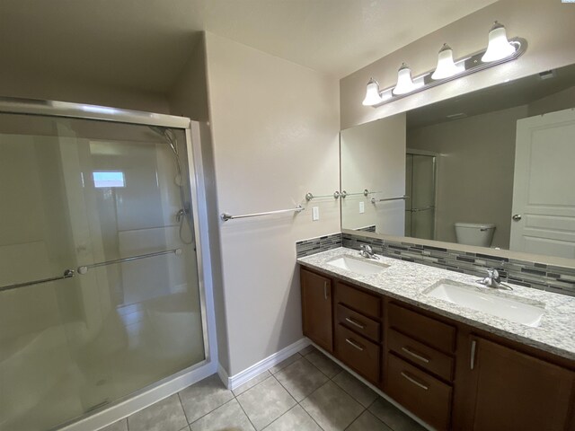 2002 Diamond Head Way, West Richland, WA 99353 - bathroom featuring double vanity, tile patterned floors, and a stall shower