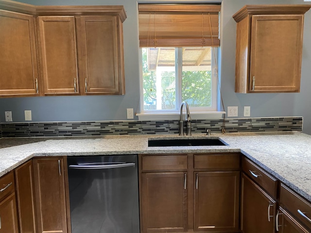 2002 Diamond Head Way, West Richland, WA 99353 - kitchen featuring dishwasher, backsplash, light stone counters, and brown cabinets
