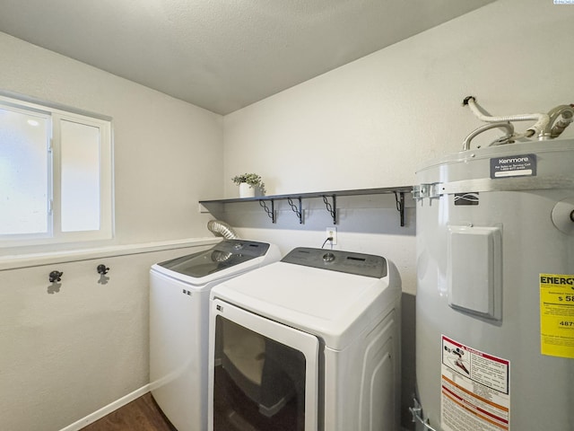 laundry area featuring a textured ceiling, laundry area, washing machine and dryer, and secured water heater