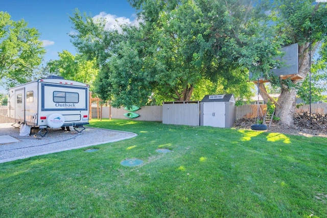 view of yard featuring a fenced backyard, an outdoor structure, and a storage unit