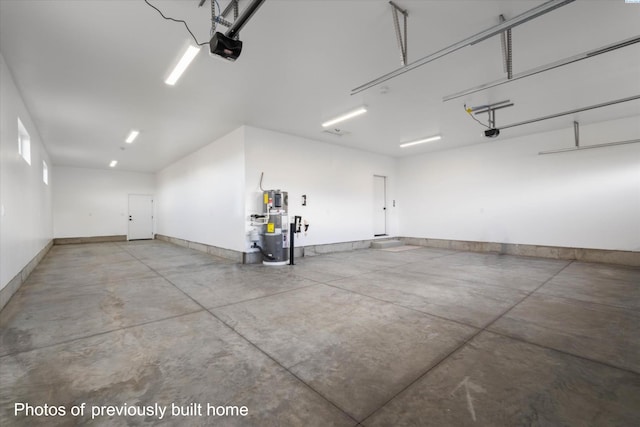 garage with a garage door opener, baseboards, and water heater