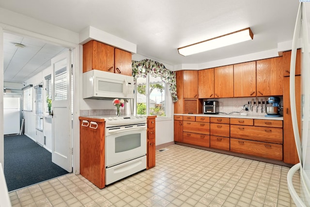 616 S Conway St, Kennewick, WA 99336 - kitchen featuring white appliances, light countertops, and brown cabinetry