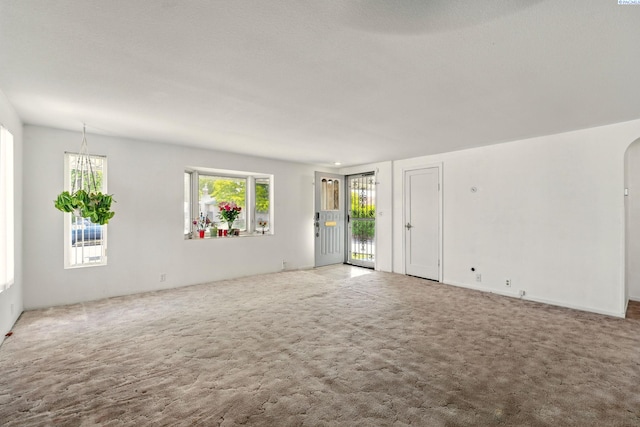 616 S Conway St, Kennewick, WA 99336 - unfurnished living room featuring carpet floors and arched walkways