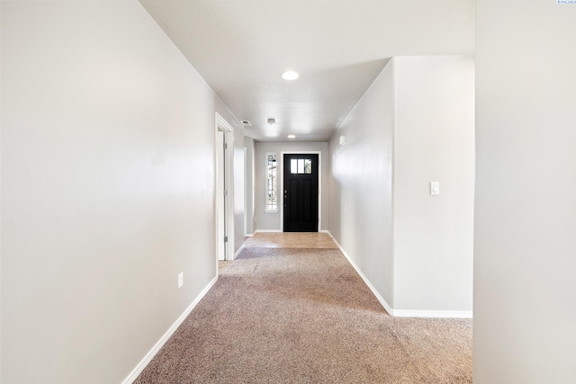 doorway with recessed lighting, carpet flooring, and baseboards