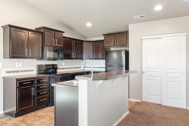 kitchen featuring a center island with sink, recessed lighting, vaulted ceiling, dark brown cabinetry, and black appliances