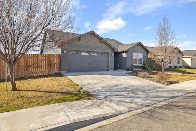 single story home with an attached garage, fence, a front lawn, and concrete driveway