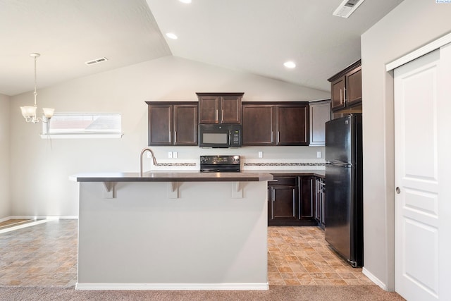 kitchen featuring a kitchen bar, visible vents, dark brown cabinets, and black appliances