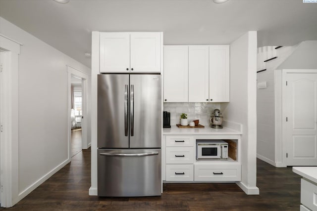 10219 W Argent Rd, Pasco, WA 99301 - kitchen with freestanding refrigerator, white microwave, light countertops, white cabinetry, and backsplash